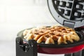 The process of making homemade waffles. Freshly baked waffles in a waffle iron. Royalty Free Stock Photo