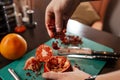 The process of making a hookah. A hookah-maker stuffs tobacco into a bowl made from a pomegranate.