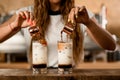 process of making macchiato with syrup. Woman pours coffee from cups into glasses Royalty Free Stock Photo
