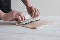 Process of making maki sushi. Cook chef hands preparing rolls with cheese, avocado and sesame seeds on wooden board Royalty Free Stock Photo