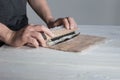 Process of making maki sushi. Cook chef hands preparing rolls with cheese, avocado and sesame seeds on wooden board Royalty Free Stock Photo