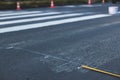 Process of making new road surface markings with a line striping machine, workers improve city infrastructure, demarcation marking Royalty Free Stock Photo