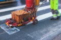 Process of making new road surface markings with a line striping machine, workers improve city infrastructure, demarcation marking Royalty Free Stock Photo