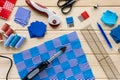Process of making patchwork quilt. Sewing accessories and fabric pieces Royalty Free Stock Photo