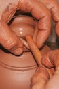 The process of making pottery. Craftsman`s hands. Formation of decorative elements