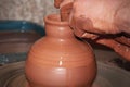 The process of making pottery. Craftsman`s hands. Work on a potter`s wheel