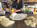 The process of making roti canai or paratha bread at the local stall in Malaysia.