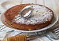 The process of making semolina pie with ingredients on a wooden background. Sprinkle cake with icing sugar. Food