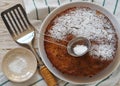 The process of making semolina pie with ingredients on a wooden background. Sprinkle cake with icing sugar. Food background