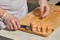 Chef making sushi. Preparing rolls with salmon