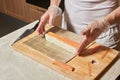 Chef making sushi. Preparing rolls with salmon