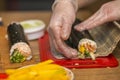 Process of making sushi and rolls. Close-up of man chef hands preparing traditional Japanese food at home or in restaurant on Royalty Free Stock Photo