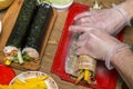 Process of making sushi and rolls. Close-up of man chef hands preparing traditional Japanese food at home or in restaurant on Royalty Free Stock Photo