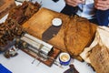 Process of making traditional cigars from tobacco leaves with own hands using a mechanical device and press. Royalty Free Stock Photo