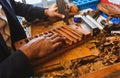 Process of making traditional cigars from tobacco leaves with own hands using a mechanical device and press. Royalty Free Stock Photo