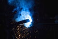 The process of manual welding of iron decorative elements. Lots of smoke. Splashes of hot metal Royalty Free Stock Photo
