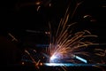 The process of manual welding by semi-automatic . Industrial welding of iron construction elements.  Splashes of hot metal Royalty Free Stock Photo