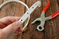 The process of manufacturing a leather belt by tanner. Puncture holes in the strap using a punch. Belt Hole Puncher Power Assist Royalty Free Stock Photo