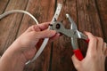 The process of manufacturing a leather belt by tanner. Puncture holes in the strap using a punch. Belt Hole Puncher Power Assist Royalty Free Stock Photo