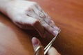 The process of nail clippingl scissors. Hand care concept.