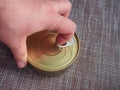 The process of opening a tin can with canned fish in tomato sauce Royalty Free Stock Photo