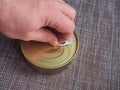 The process of opening a tin can with canned fish in tomato sauce Royalty Free Stock Photo