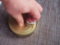 The process of opening a tin can with canned fish in tomato sauce Royalty Free Stock Photo
