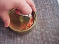 The process of opening a tin can with canned fish in tomato sauce Royalty Free Stock Photo