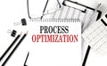 PROCESS OPTIMIZATION word on notepad with clipboard , chart and calculator, business concept Royalty Free Stock Photo