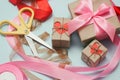 Process of packaging gift boxes. Thanks gifts. Wedding presents. Pink ribbon and yellow scissors. Royalty Free Stock Photo