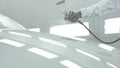 Process of painting a white car in a spray booth. Man using a spray gun Royalty Free Stock Photo