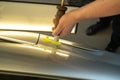 Process Of Paintless Dent Repair On Car Body. Technician s Hands With Puller Fixing Dent On Rear Car Fender. PDR Removal