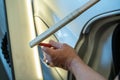 Process Of Paintless Dent Repair On Car Body. Technician s Hands With Puller Fixing Dent On Rear Car Fender. PDR Removal