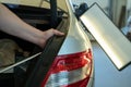 Process Of Paintless Dent Repair On Car Body. Technician s Hands With Puller Fixing Dent On Rear Car Fender. PDR Removal