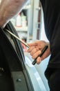 Process Of Paintless Dent Repair On Car Body. Technician s Hands With Puller Fixing Dent On Rear Car Fender. PDR Removal