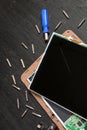 Process of PC Tablet device repair near screwdriver and bit on black wooden background. Disassembled. Broken glass, screen destroy Royalty Free Stock Photo