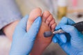 Process pedicure close-up, polishing feet, unrecognizable people. blurred face.