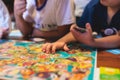 Process of playing board game and having fun with friends and family indoors, board game concept, group of kids children play Royalty Free Stock Photo