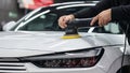 Process of polishing white car hood surface using orbital polishing machine. Royalty Free Stock Photo