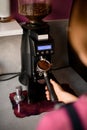 process of pouring ground coffee into portafilter i from the modern coffee grinder Royalty Free Stock Photo