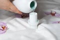 The process of pouring natural eco gel liquid laundry detergent from the bottle into the cap Royalty Free Stock Photo