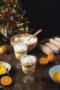 Process of preparation christmas layered dessert, no bake cheesecake or trifle with tangerines and chocolate