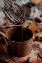 Process of preparation of delicious homemade dark chocolate. Whisk mixer, vintage tableware, ingredients on the table. Gourmet