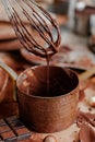 Process of preparation of delicious homemade dark chocolate. Whisk mixer, vintage tableware, ingredients on the table. Gourmet