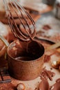 Process of preparation of delicious homemade dark chocolate. Whisk mixer, vintage tableware, ingredients on the table. Gourmet