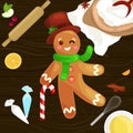 Process of preparing Christmas treats and sweets on a wooden kitchen table. Gingerbread man and ingredients for cooking