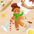 Process of preparing Christmas treats and sweets on a wooden kitchen table. Gingerbread man and ingredients for cooking