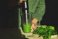 Process of preparing green detox smoothie with blender, young man hands cooking healthy smoothie with fresh fruits and greens spin Royalty Free Stock Photo