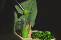 Process of preparing green detox smoothie with blender, young man hands cooking healthy smoothie with fresh fruits and greens spin Royalty Free Stock Photo