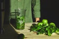 Process of preparing green detox smoothie with blender, young man hands cooking healthy smoothie with fresh fruits and greens spin Royalty Free Stock Photo